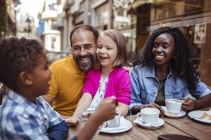 Close up of a young family enjoying time together in a cafe